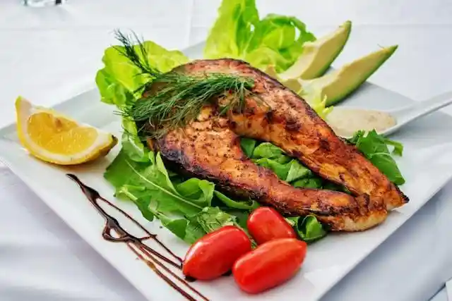 Fish, salad, and cherry tomatoes